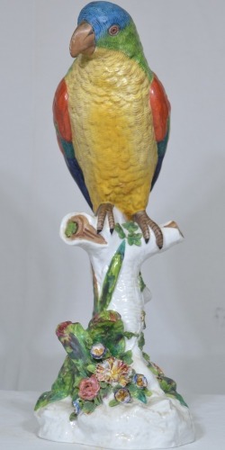 Figurine - Maker unknown, Parrot on Stump, over glaze painted porcelain, Makers mark to base. H 46cm. Minor chipping to flowers.