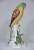 Figurine - Maker unknown, Parrot on Stump, over glaze painted porcelain, Makers mark to base. H 46cm. Minor chipping to flowers. - 2