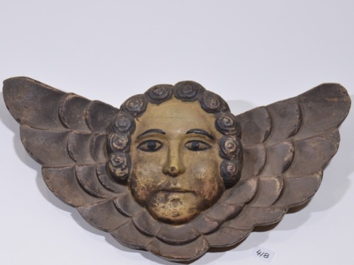 Religious Artifact - Spanish colonial winged angel, Carved timber with painted highlights, D 32cm.