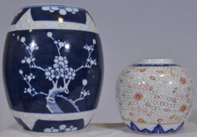 Asian Artifact x 2 - 1 x Blue and white barrel shaped urn with lid with cherry blossom design H 23 cm. 1 x Ginger jar with translucent appearance (inside) in the cloisonne style of decoration H 13 cm. Most unusual.