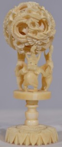 Asian Artifact - Carved Puzzle Ball. Non-composite carving of elephants holding a detachable puzzle ball. H 11cm.