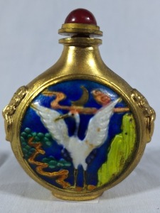 Asian Artifact - Snuff Bottle. Metal based bottle with ovoid shaped design featuring hand painted crane. Complete with metal spoon stopper. Most unusual. H 7cm.