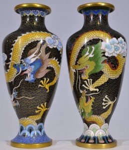 Asian Artifact x 2 - Two cloisonne vases featuring black background with yellow dragon. H 21cm. Unusual narrow base.