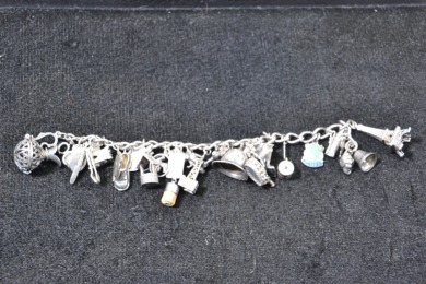 Jewellery - Silver Charm Bracelet with a large number of marked silver charms. Weighs 68.8g