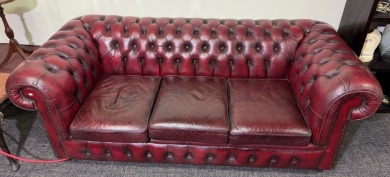 Furniture - Chesterfield style 3 seat lounge with red hues.